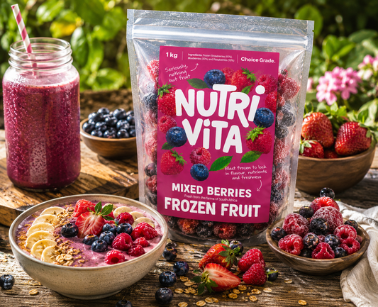 NutriVita mixed berries frozen fruit package with a smoothie and bowl of fruit on a wooden table.